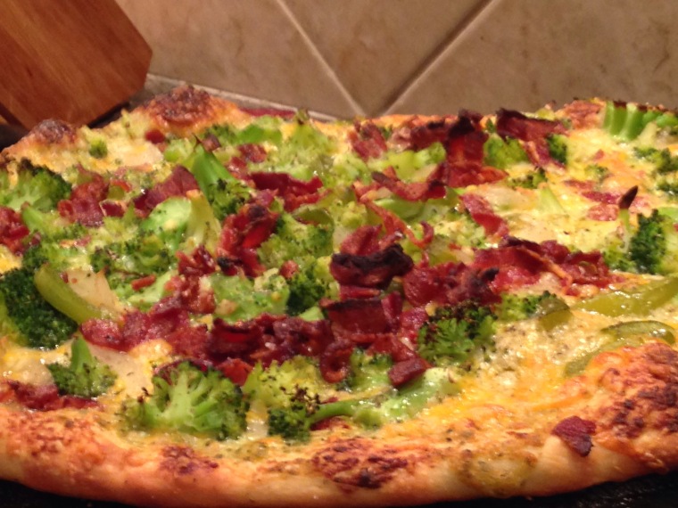 Broccoli, bacon and tomato pizza with cheddar cheese